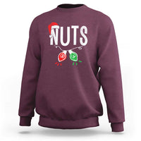Maroon crewneck sweatshirt with “NUTS” holiday graphic, long sleeves