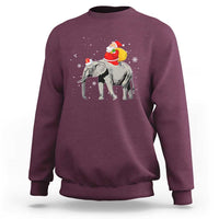 Maroon crewneck sweatshirt with Santa riding an elephant graphic on the back