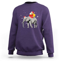 Purple crewneck sweatshirt with Santa riding an elephant graphic on the back