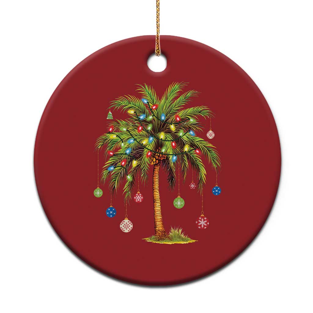 Red round palm tree Christmas ornament with multicolor lights and hanging gold string.