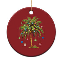 Red round palm tree Christmas ornament with multicolor lights and hanging gold string.