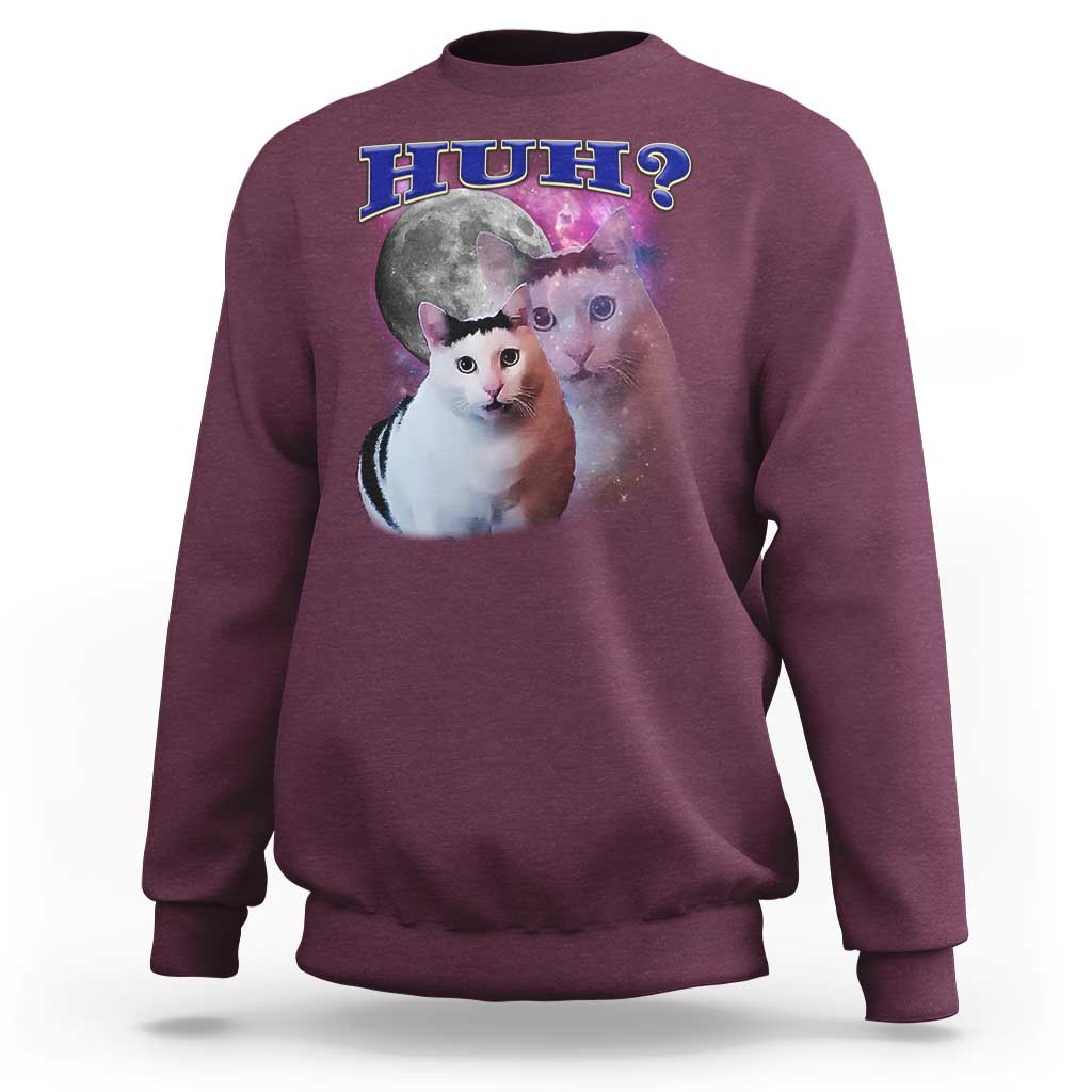 Maroon crewneck sweatshirt with cat graphic and “HUH?” text on the front.