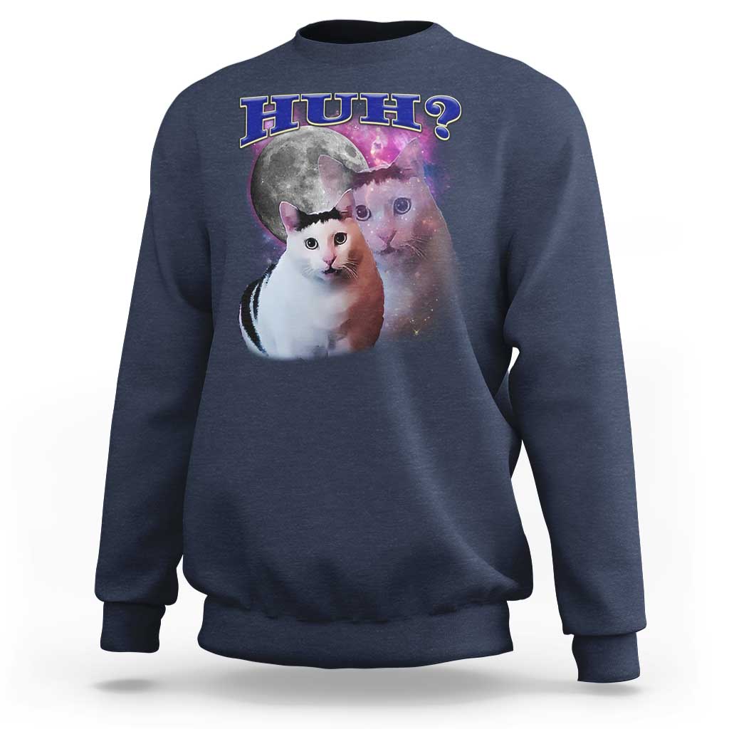 Navy crewneck sweatshirt with cat graphic and “HUH?” text on the front.