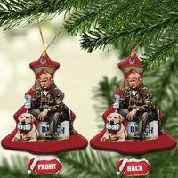 Red bell-shaped Christmas ornament with gold loop, printed portrait of man and dog; two angles.