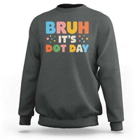 Dark heather green crewneck sweatshirt with colorful "BRUH IT'S DOT DAY" graphic on back