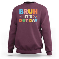 Maroon crewneck sweatshirt with colorful "BRUH IT'S DOT DAY" graphic on back