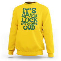 Yellow crewneck sweatshirt with dark "It's Never Luck" "It's Always God" text graphic