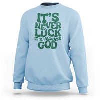 Light blue crewneck sweatshirt with green "It's Never Luck" "It's Always God" text graphic