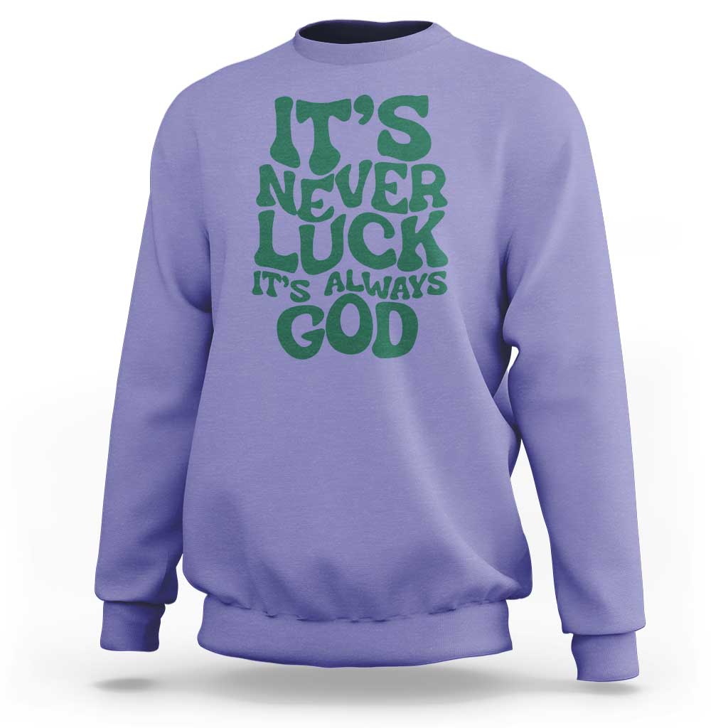 Purple crewneck sweatshirt with green "It's Never Luck" "It's Always God" text graphic