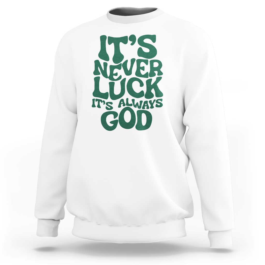 White crewneck sweatshirt with green "It's Never Luck" "It's Always God" text graphic