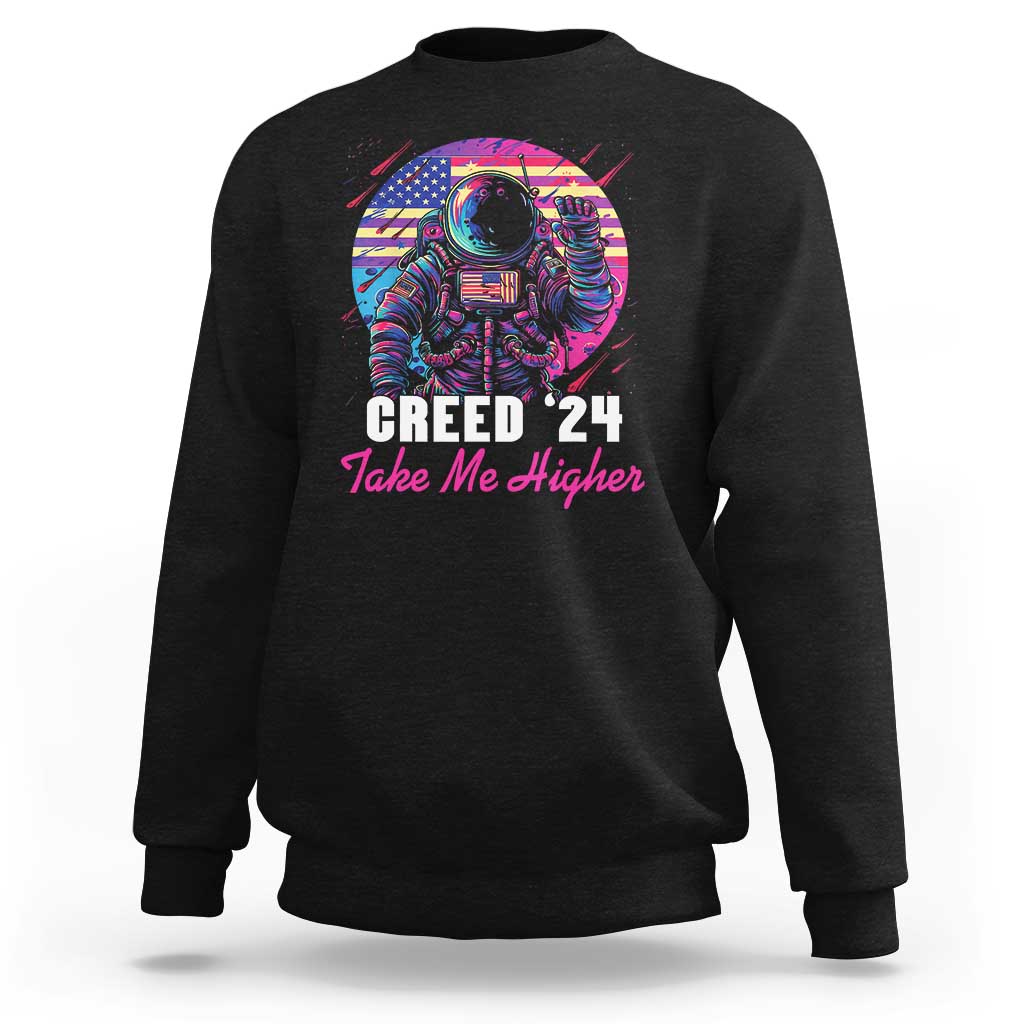 Black crewneck sweatshirt with astronaut graphic and “Creed ’24 Take Me Higher” text