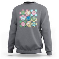 Easter-themed sweatshirt in charcoal gray with colorful bunny-and-egg square graphic