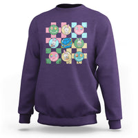 Easter-themed sweatshirt in purple with colorful bunny-and-egg square graphic