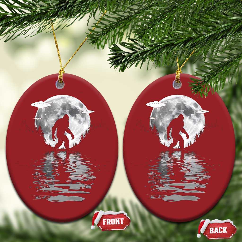 Two red oval Bigfoot Christmas ornaments with silver moon and reflection, gold loops