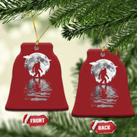 Pair of red bell-shaped Bigfoot Christmas ornaments with silver moon and reflection
