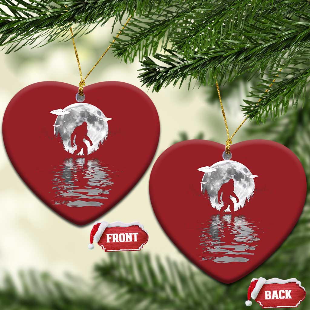 Two red heart-shaped Bigfoot Christmas ornaments with silver moon and reflection