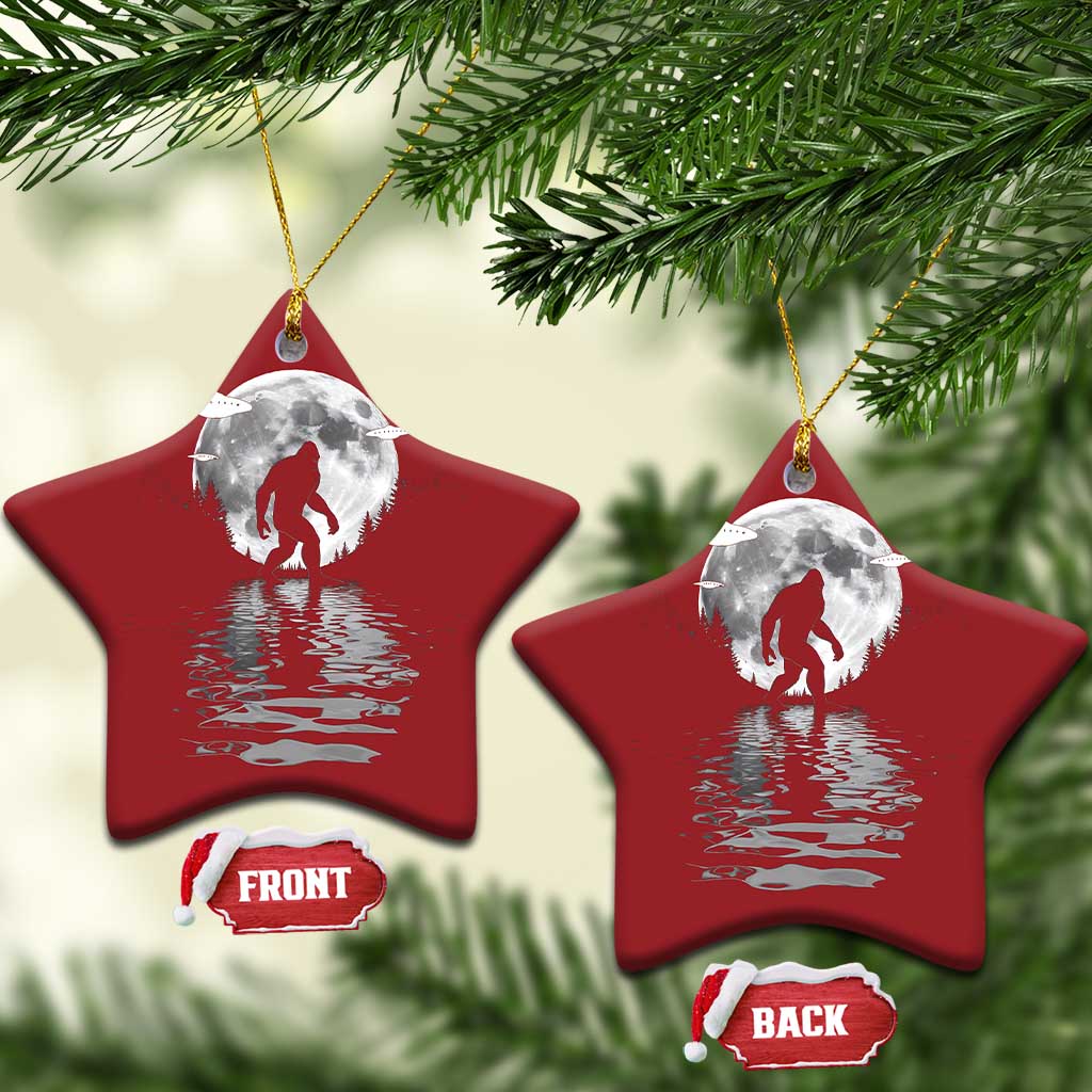 Two red star-shaped Bigfoot Christmas ornaments with silver moon and reflection