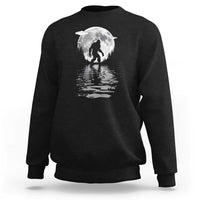 Black crewneck sweatshirt with Bigfoot under a moon graphic and reflection print
