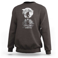 Dark chocolate crewneck sweatshirt with Bigfoot under a moon graphic and reflection print