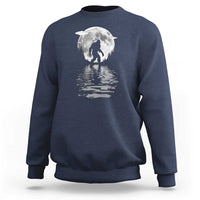 Navy crewneck sweatshirt with Bigfoot under a moon graphic and reflection print