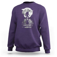 Purple crewneck sweatshirt with Bigfoot under a moon graphic and reflection print