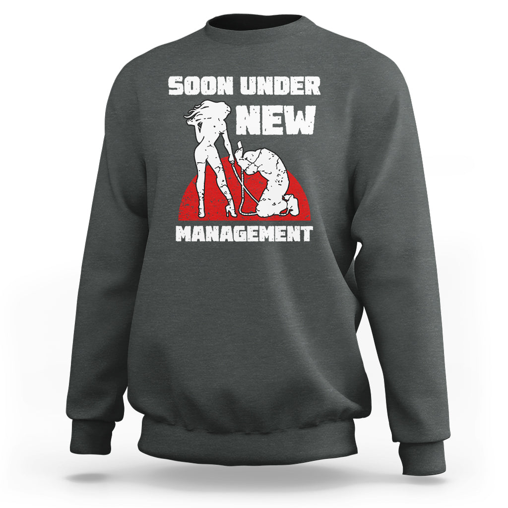 Dark heather gray crewneck sweatshirt with “Soon Under New Management” graphic