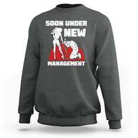 Dark heather gray crewneck sweatshirt with “Soon Under New Management” graphic