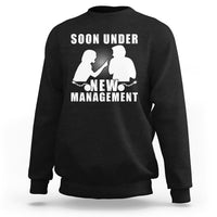 Black crewneck sweatshirt with “Soon Under New Management” graphic and silhouettes.