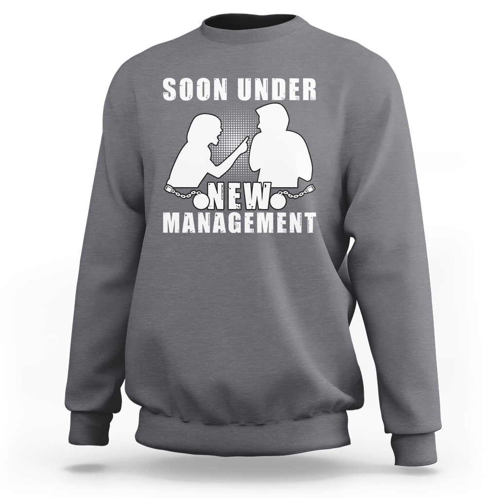 Charcoal gray crewneck sweatshirt with “Soon Under New Management” graphic and silhouettes.