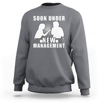 Charcoal gray crewneck sweatshirt with “Soon Under New Management” graphic and silhouettes.