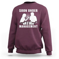 Maroon crewneck sweatshirt with “Soon Under New Management” graphic and silhouettes.