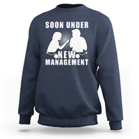Blue crewneck sweatshirt with “Soon Under New Management” graphic and silhouettes.