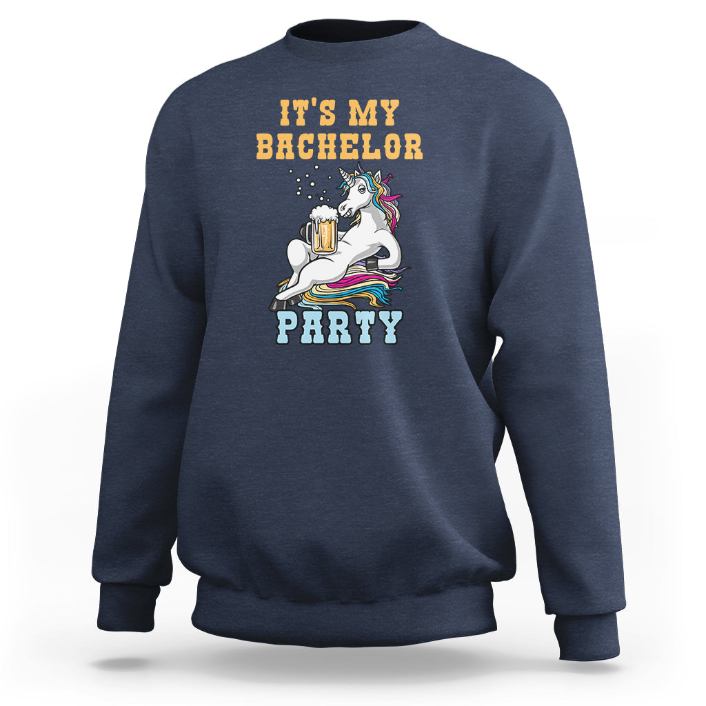 Navy crewneck sweatshirt with “It’s My Bachelor Party” graphic and unicorn holding a beer