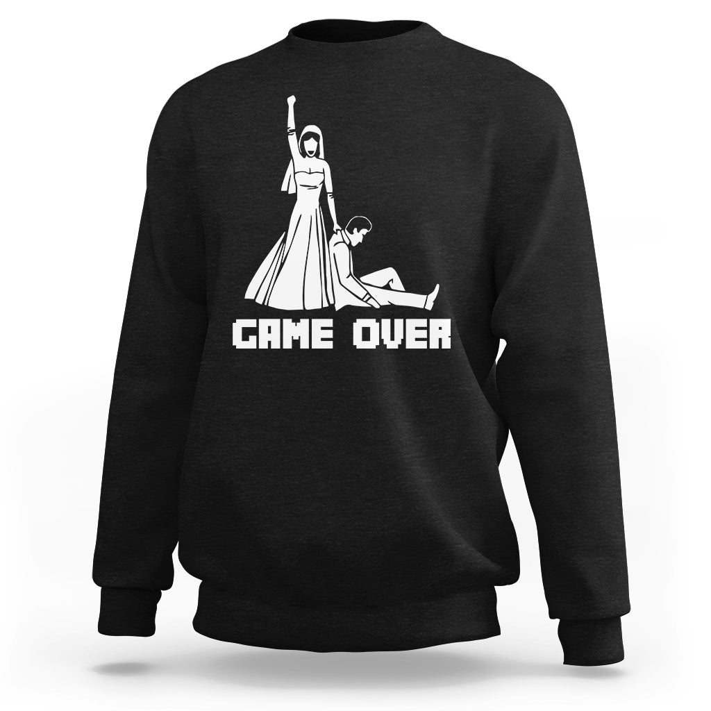 Black crewneck sweatshirt with white "GAME OVER" graphic and character illustration