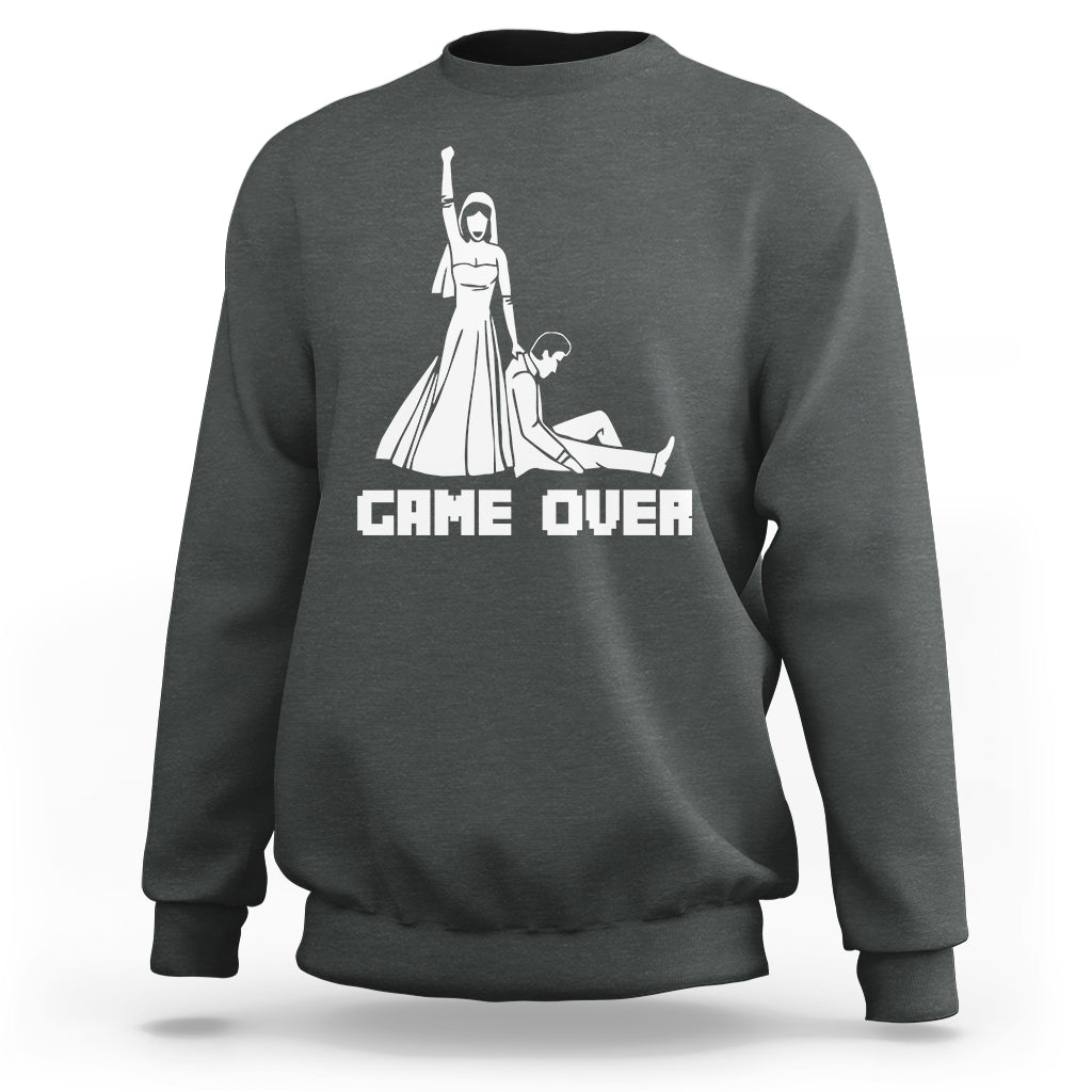 Dark gray crewneck sweatshirt with white "GAME OVER" graphic and character illustration