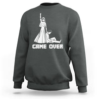 Dark gray crewneck sweatshirt with white "GAME OVER" graphic and character illustration