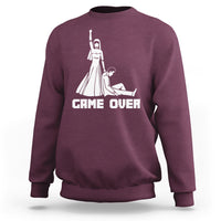 Maroon crewneck sweatshirt with white "GAME OVER" graphic and character illustration