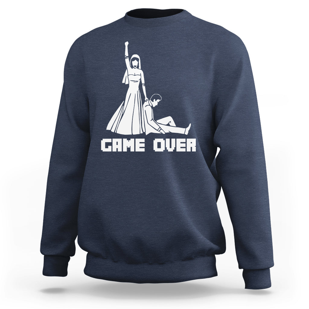 Navy crewneck sweatshirt with white "GAME OVER" graphic and character illustration
