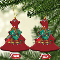 Red bell-shaped Bigfoot Christmas ornaments with Santa hat, decorated tree and gift boxes