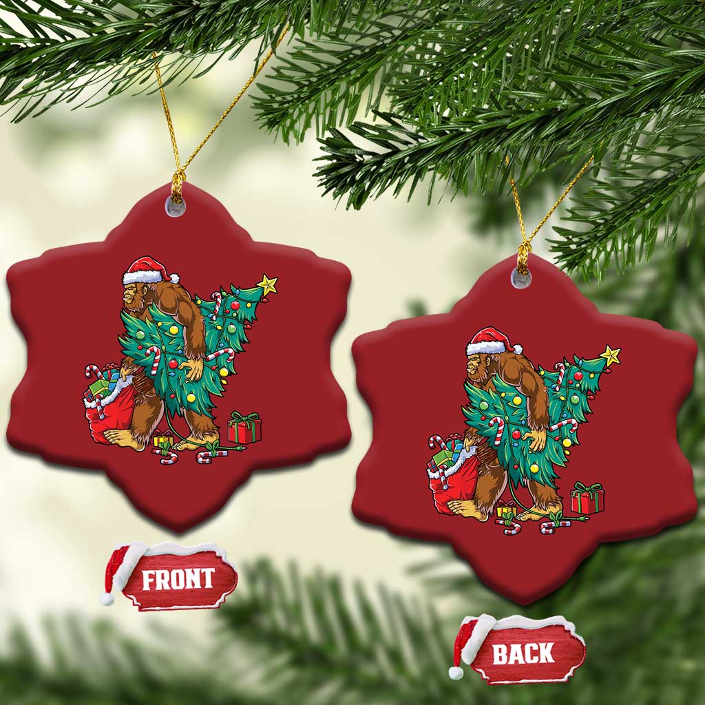 Two red star-shaped Bigfoot Christmas ornaments with Santa hat, decorated tree and gifts