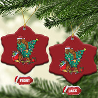 Two red star-shaped Bigfoot Christmas ornaments with Santa hat, decorated tree and gifts