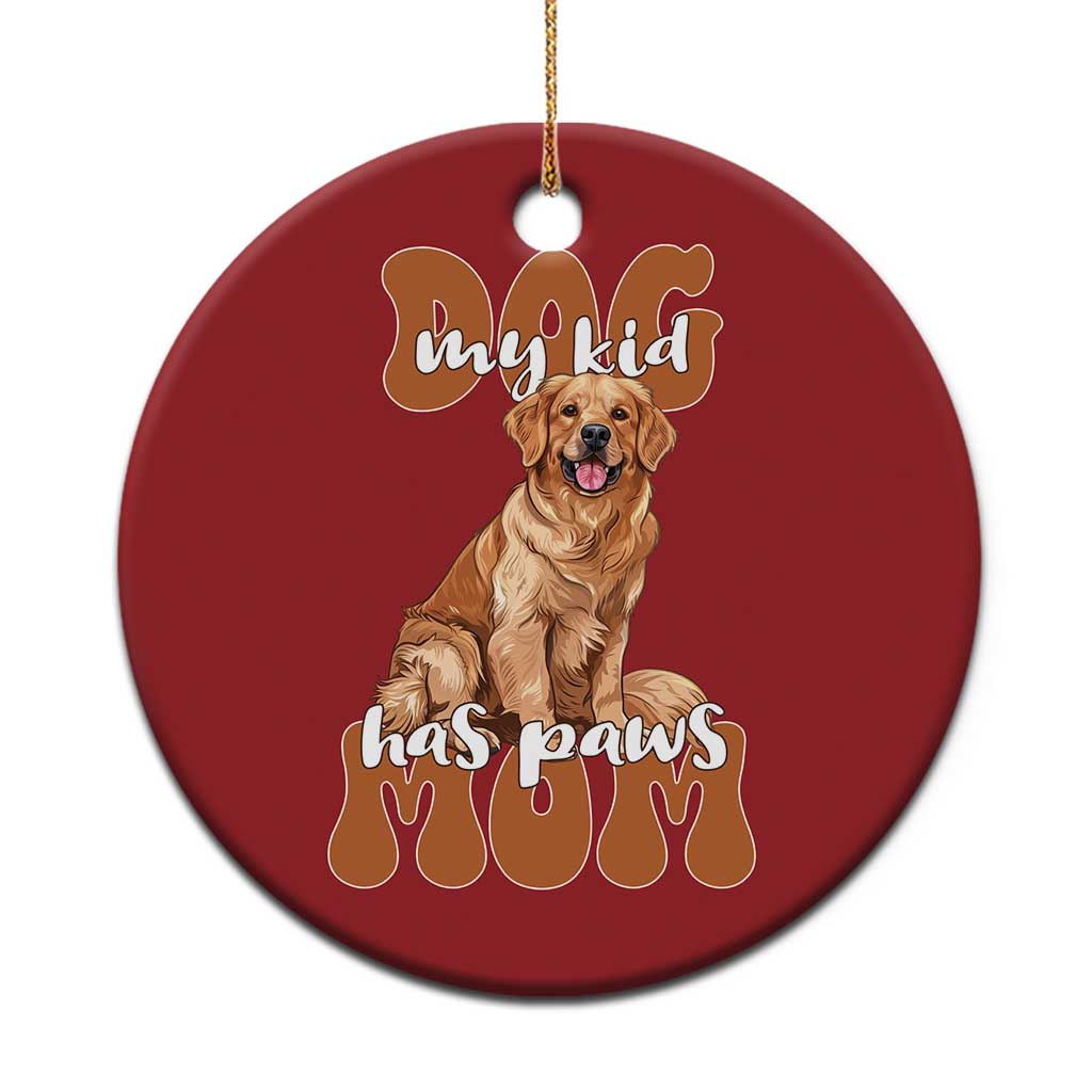Red round golden retriever Christmas ornament with “My kid has paws” text and a paw-print base
