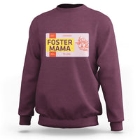 Maroon sweatshirt with “Foster Mama” back graphic