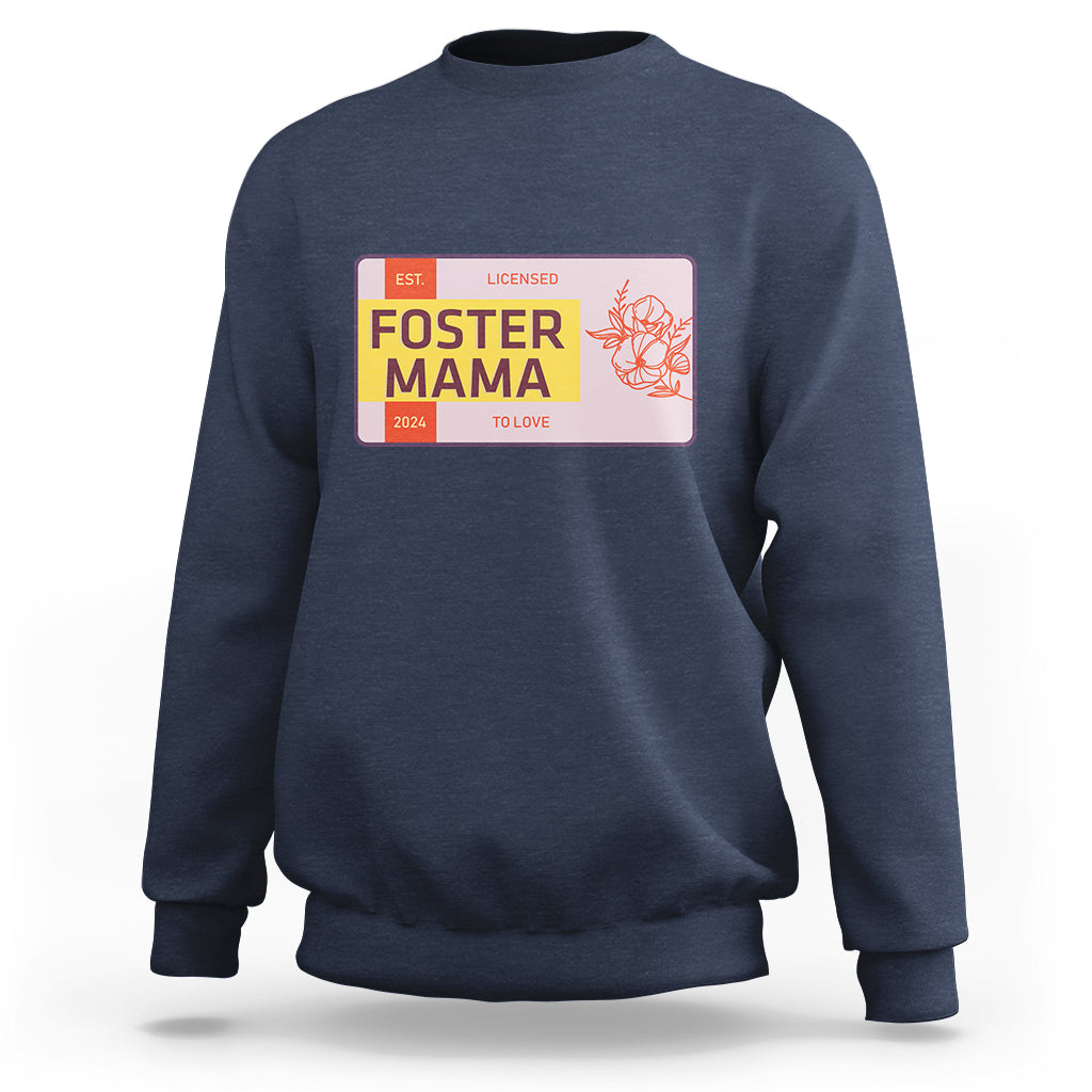 Navy sweatshirt with “Foster Mama” back graphic