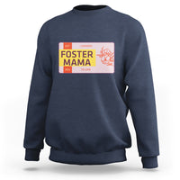 Navy sweatshirt with “Foster Mama” back graphic