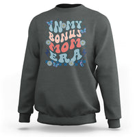 Dark heather gray crewneck sweatshirt with colorful 'Bonus Mom' graphic on chest