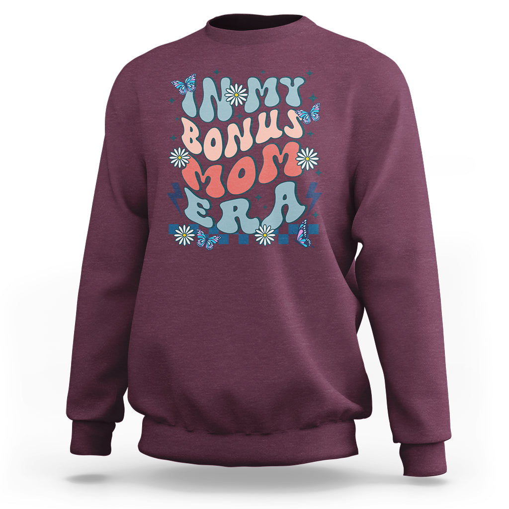Maroon crewneck sweatshirt with colorful 'Bonus Mom' graphic on chest