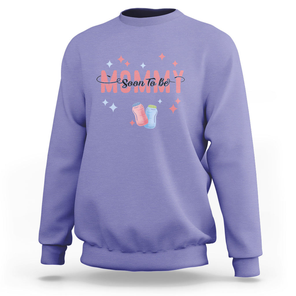 Violet maternity sweatshirt with “Soon To Be” graphic, baby shoes, and star accents