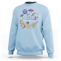 Light blue crewneck sweatshirt with colorful space-themed front graphic and logo