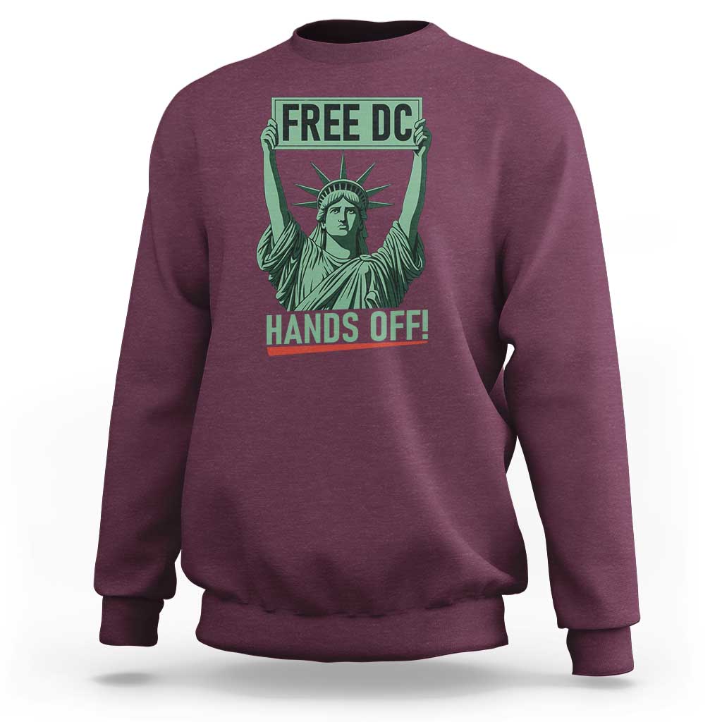 Maroon crewneck sweatshirt with 'FREE DC HANDS OFF!' Statue of Liberty graphic.